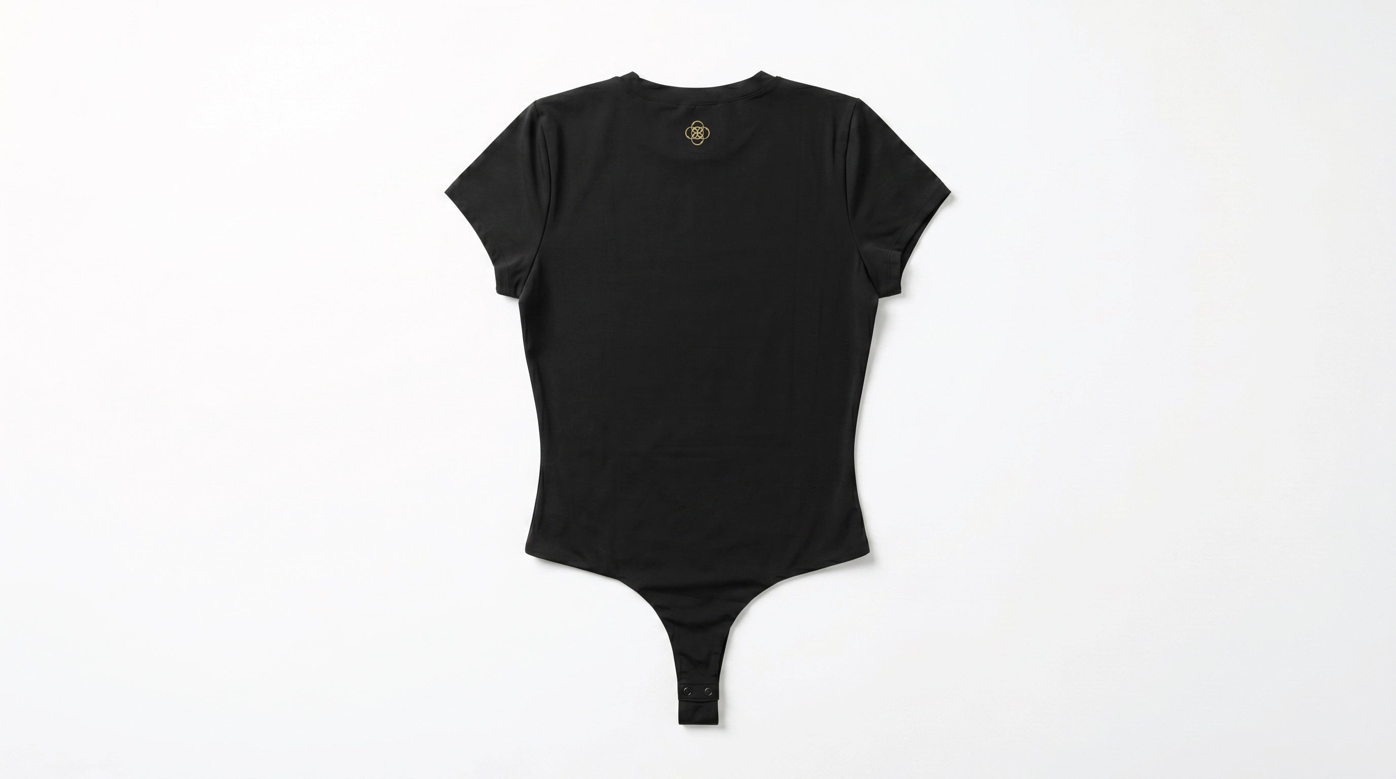 Back side of a black colored bodysuit on a white background. The Five Realms logo is in gold near the neck collar. Thong bottom with snap closure.