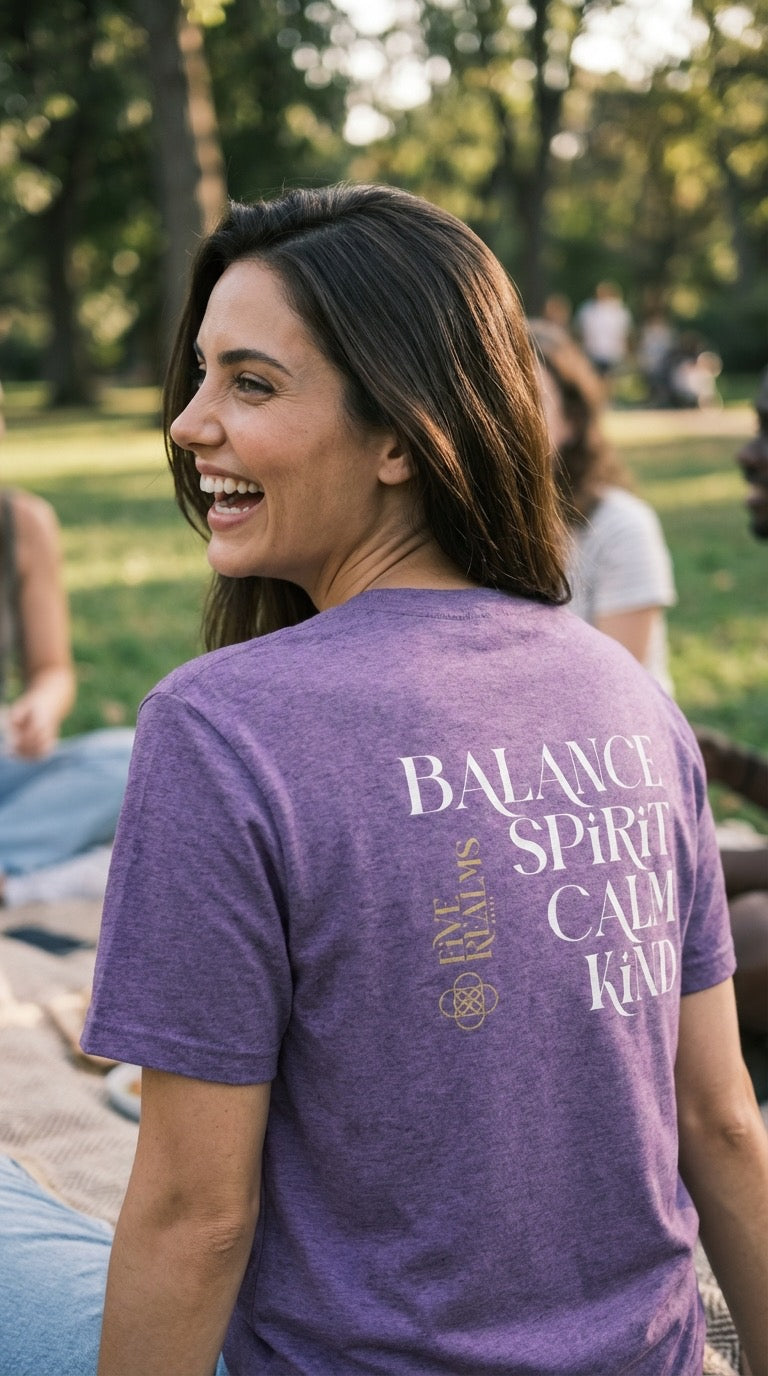 Woman wearing a purple t-shirt with text in a park