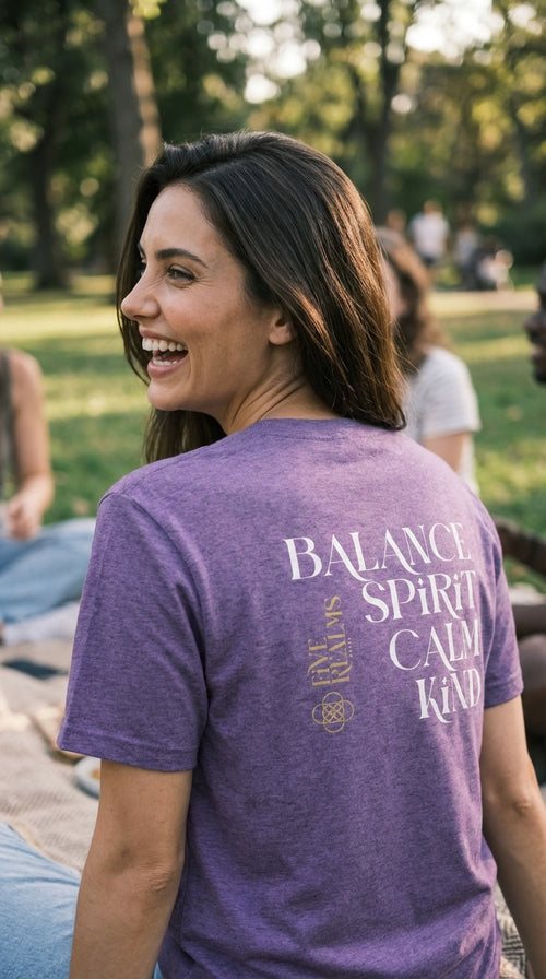 Woman wearing a purple t-shirt with text in a park