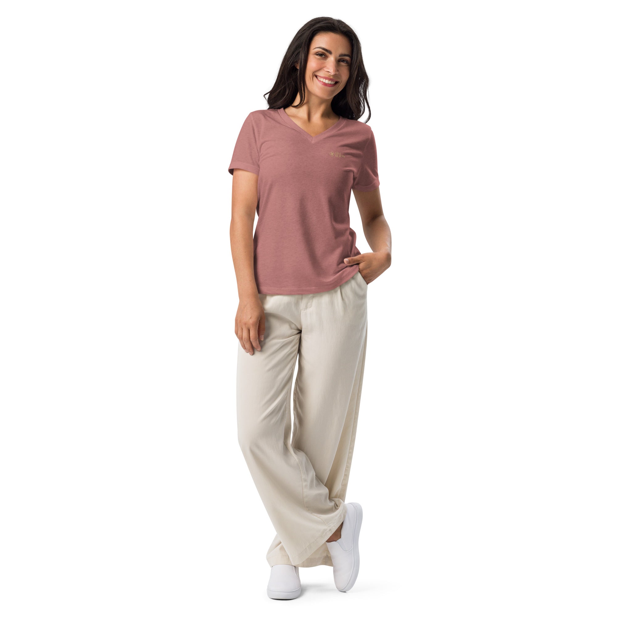 Woman wearing a pink shirt and beige pants on a white background